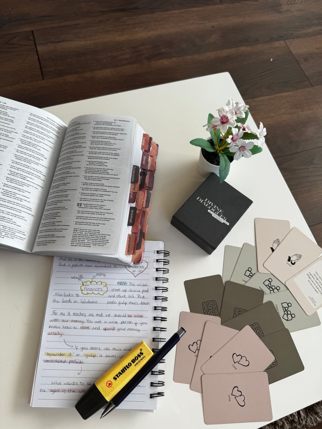 Christian card game laid out with Bible, notebook and highlighter for faith based reflection